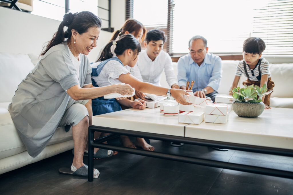Modern family eating take-out food together - 住宅AIコンシェルジュ